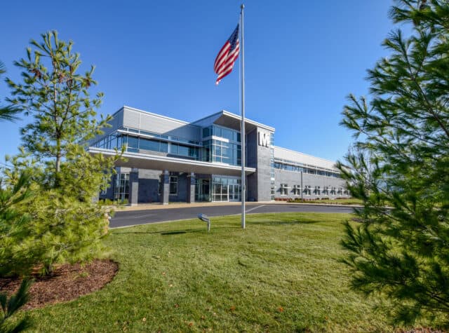 view of M3 Insurance building with American flag in grassy area Livesey Company, Commercial Real Estate Development, Wisconsin